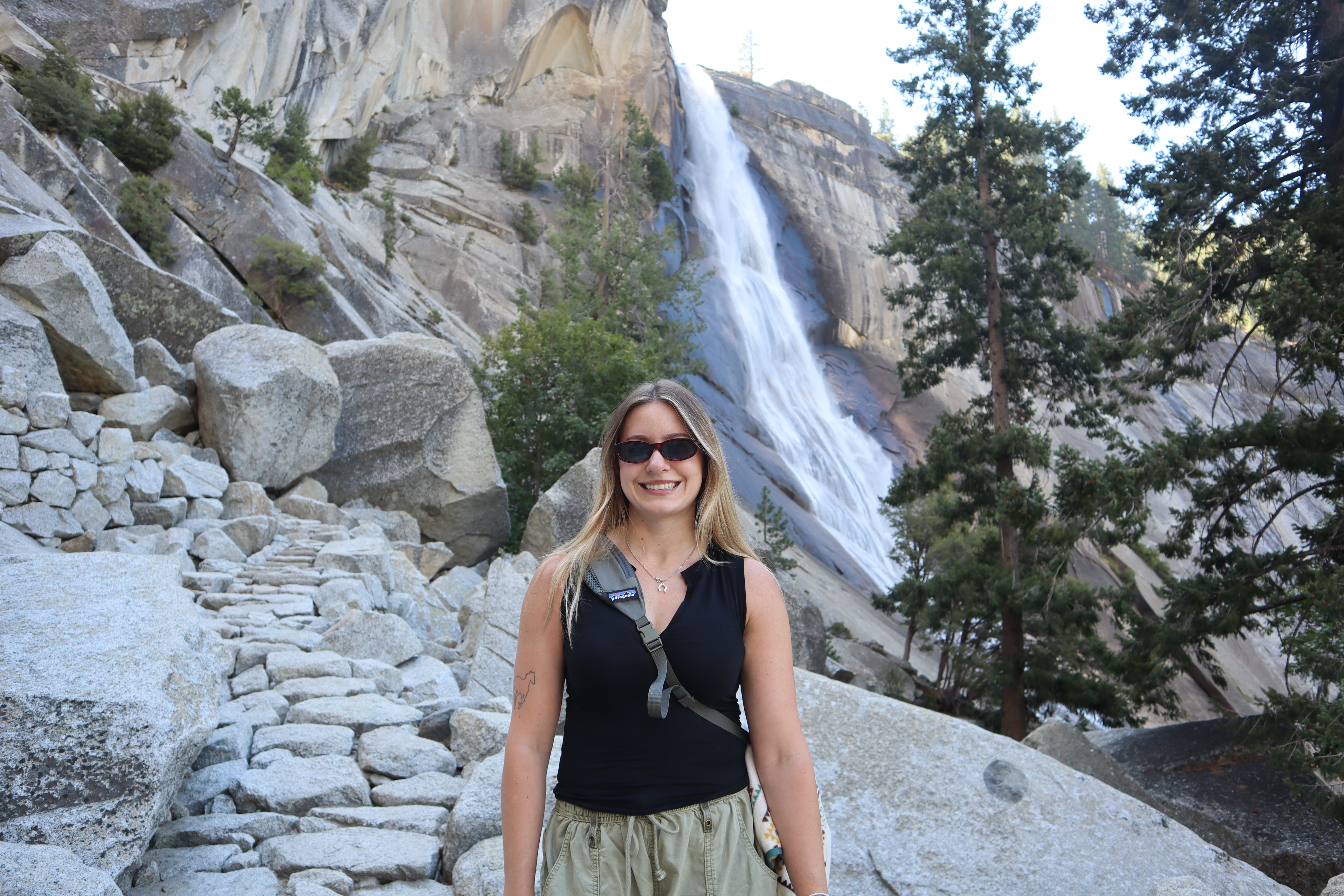 Veronika outdoors beside a waterfall